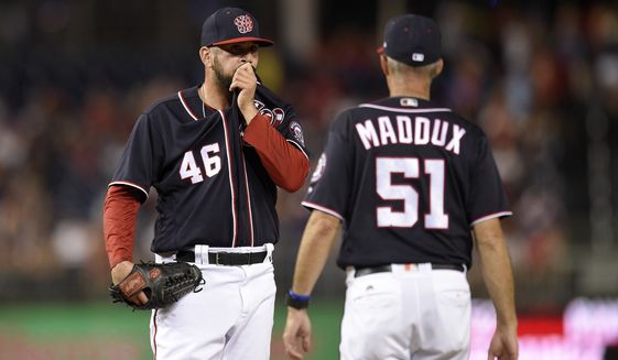 Washington Nationals pitching coach Mike Maddux (51) walks to the mound to meet with relief pitcher Oliver Perez (46) during the eighth inning of a baseball game against the Atlanta Braves, Friday, July 7, 2017, in Washington. (AP Photo/Nick Wass)