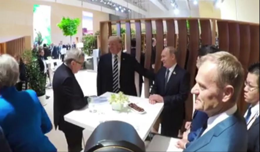 In this image taken from video U.S. President Donald Trump, center left, meets with the Russian President Vladimir Putin, center right,  during the G-20 summit in Hamburg, Germany Friday July 7, 2017. (Steffen Kugler/German Government via AP)