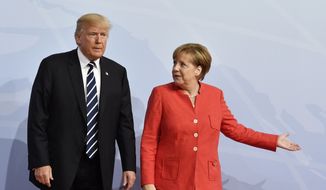 German Chancellor Angela Merkel, right, greets U.S. President Donald Trump at the start of the G-20 meeting in Hamburg, northern Germany, on Friday, July 7, 2017. Leaders of the world&#39;s top economies will gather from July 7 to 8, 2017. (John MacDougall/Pool Photo via AP)