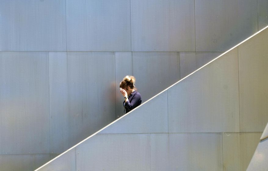 A woman shades her eyes from the afternoon sun on a stairway along the Disney Music Hall in downtown Los Angeles on Friday, July 7, 2017. Southern California faces more blistering heat as firefighters around the state work to corral wildfires. The National Weather Service says high temperatures between 100 and 110 degrees will be common away from the coast Friday and Saturday while some coastal sections could see highs into the 90s. (AP Photo/Richard Vogel)