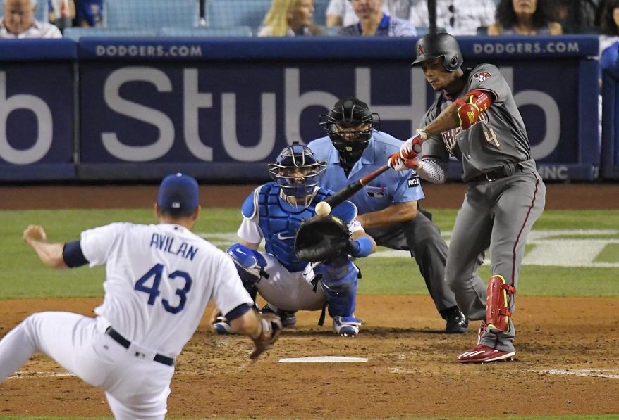 Arizona Diamondbacks' Ketel Marte hits a solo home run off Los Angeles Dodgers relief pitcher Luis Avilan, left, during the eighth inning of a baseball game, Thursday, July 6, 2017, in Los Angeles. (AP Photo/Mark J. Terrill)