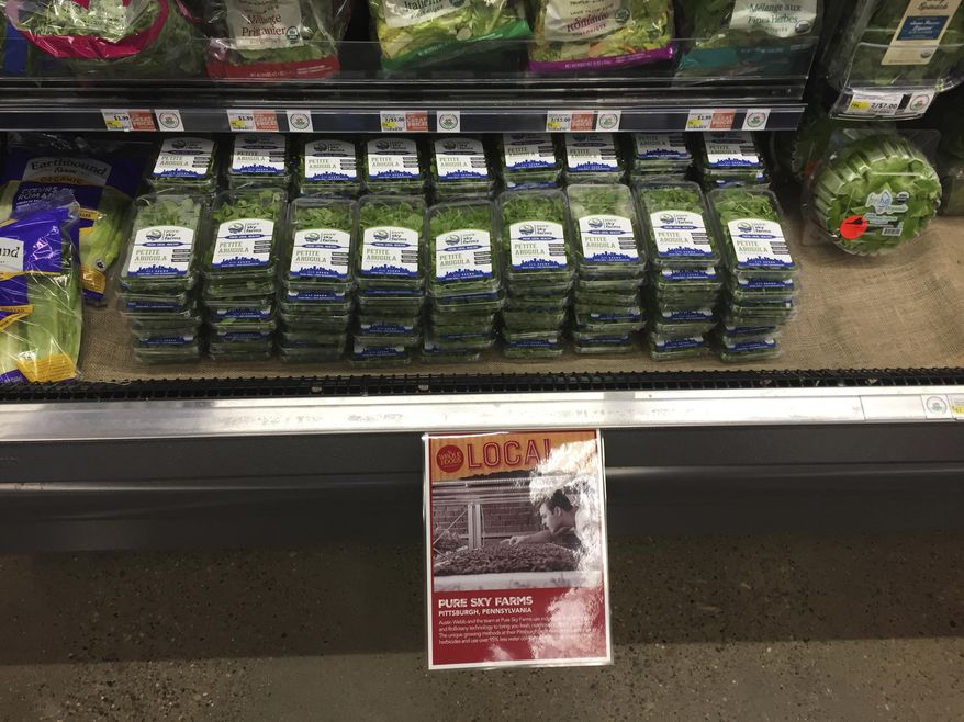 ADVANCE FOR RELEASE SATURDAY, JULY 8, 2017, AT 3:01 A.M. EDT. AND THEREAFTER - In this undated photo, RoBotany's arugula and cilantro is for sale at the new Whole Foods in the South Hills, Pa. Robots could grow your next salad inside an old steel mill on Pittsburgh's South Side. And the four co-founders of the robotic, indoor, vertical farming startup RoBotany could next tackle growing the potatoes for the french fries to top it. "We're techies, but we have green thumbs," said Austin Webb, one of the startup's co-founders. (Andrew Russell/Pittsburgh Tribune-Review via AP)