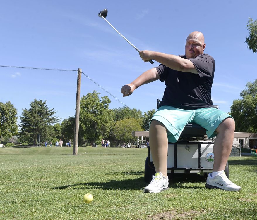 In a Friday, June 16, 2017 photo, stroke survivor Josh Mendel makes a one-handed drive at Nibley Park Golf Course in Salt Lake City, Utah. Mendel was among stroke survivors connecting with the game of golf at the Saving Strokes Golf Clinic. (Al Hartmann/The Salt Lake Tribune via AP)