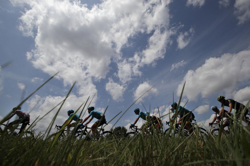 The pack with team Astana riders, in blue, passes during the seventh stage of the Tour de France cycling race over 213.5 kilometers (132.7 miles) with start in Troyes and finish in Nuits-Saint-Georges, France, Friday, July 7, 2017. (AP Photo/Christophe Ena)