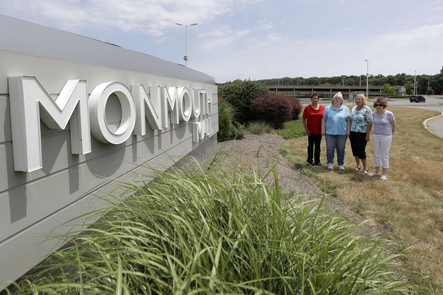 In this Wednesday, July 5, 2017, photo, Barbara Denegar, from left, Evelyn Guerra, Sara Breslow and Judy Bretzger pose for a picture near the entrance to the Monmouth Mall in Eatontown, N.J. The four women are the plaintiffs in a court case against the town, which they claim gave Kushner Cos. special treatment and sped through approvals for its proposal to build an apartment complex on the mall parking lot. Attorneys for the town and Kushner Cos. say that's not true and that opponents could block the construction of much needed affordable housing. (AP Photo/Julio Cortez)
