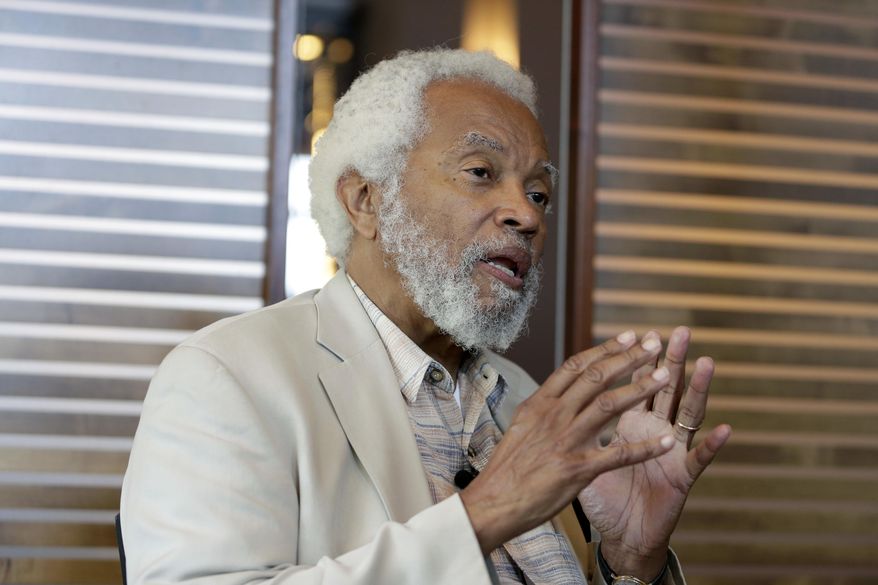 In this June 28, 2017 photo, Junius Williams talks to a reporter about the Newark riots of 1967 in Newark, N.J. Fifty years ago Williams was a law student at Yale University fighting gentrification in Newark when the riots broke out. As he was driving friends home on the second night of the riots, Williams faced down a police officer wielding a shotgun during a traffic stop. He was spared, he says, when a sergeant diffused the situation by searching Williams’ car for guns. He found only law books. (AP Photo/Seth Wenig)