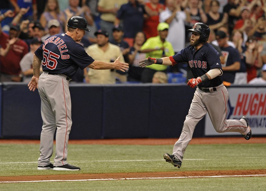 Boston Red Sox third base coach Brian Butterfield, left, congratulates Dustin Pedroia who hit a two-run home run off Tampa Bay Rays starter Jake Odorizzi during the third inning of a baseball game Friday, July 7, 2017, in St. Petersburg, Fla. (AP Photo/Steve Nesius)