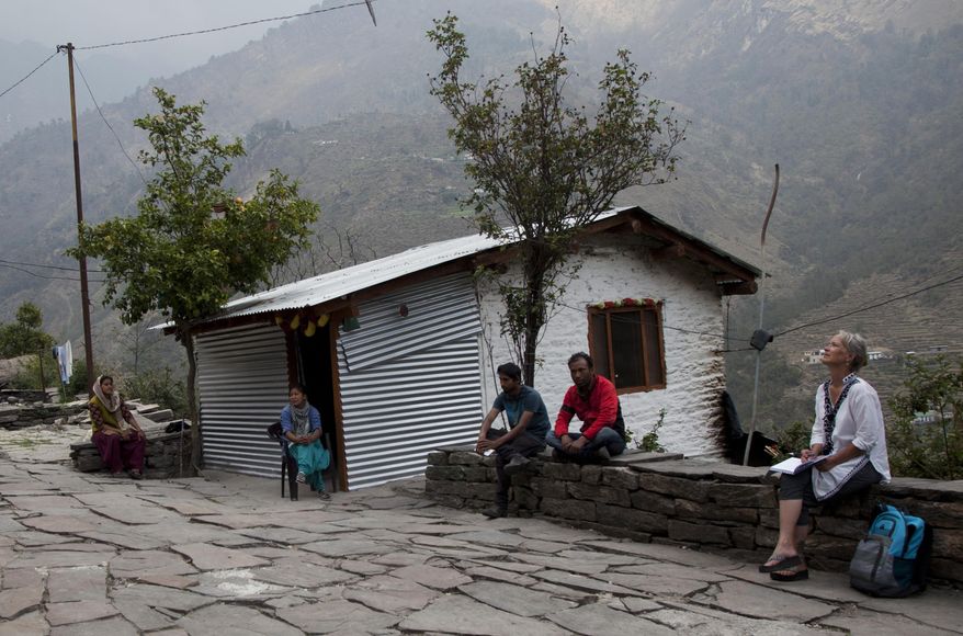 In this March 28, 2017 photo, Elizabeth Brenner, right, gazes skywards during her meeting with locals in Lilam village in the mountainous state of Uttarakhand in north India. Brenner&#39;s son Thomas Plotkin fell off a hiking trail near the village while on a study abroad trip in 2011. His body was never found. Brenner is on a journey through India tracing the last footsteps of her son and talking to locals who were involved in the rescue efforts more than five-years-ago. (AP Photo/Rishabh R. Jain)