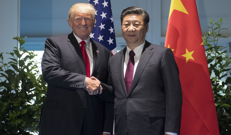 US President Donald Trump and Chinese President Xi Jinping, right, shake hands as they arrive for a meeting on the sidelines of the G-20 Summit in Hamburg, Germany, Saturday, July 8, 2017.  (Saul Loeb/Pool Photo via AP)