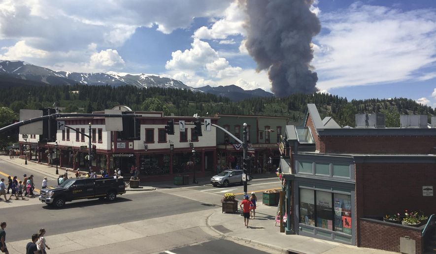 FILE - This Wednesday, July 5, 2017 file photo provided by Tony Cooper a wildfire burning near Breckenridge, Colo. The fire has not spread much since this dramatic flareup. Residents in the mountain town are under orders to be ready to leave if that changes but, in the meantime, it continues to welcome visitors that help drive its economy. (Tony Cooper via AP, File)