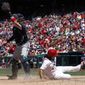 Washington Nationals third baseman Anthony Rendon scores on an RBI single by Chris Heisey, as Atlanta Braves catcher Tyler Flowers reaches to make the catch, during the fourth inning of a baseball game at Nationals Park, Sunday, July 9, 2017, in Washington. (AP Photo/Alex Brandon)