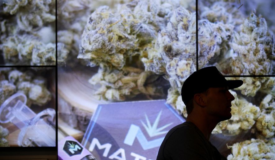A man waits in line at The Source dispensary, Saturday, July 1, 2017, in Las Vegas. Recreational marijuana became legal in Nevada on Saturday. (AP Photo/John Locher)