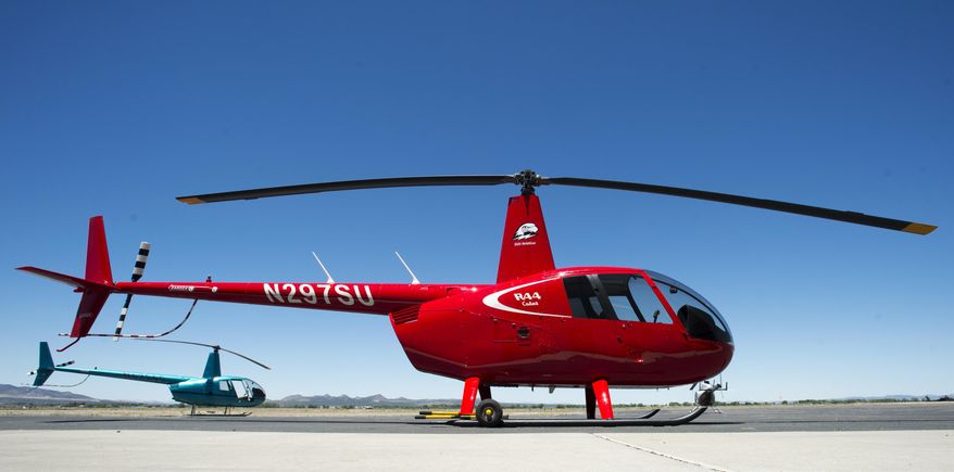 This June 14, 2017 photo shows a new R44 Cadet helicopter, used in the Southern Utah University Flight School in Cedar City, Utah. The university bought new airplanes to try and lure students amid a pilot shortage. (Rick Egan/The Salt Lake Tribune via AP)