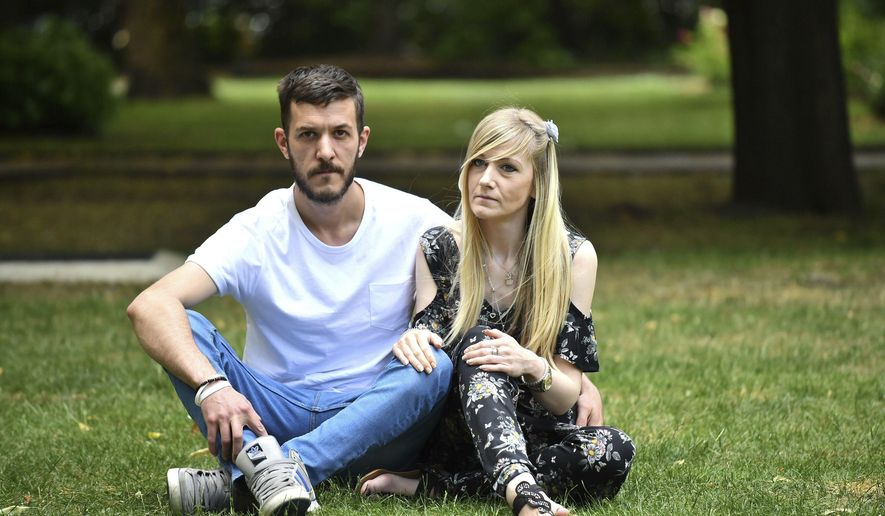 Parents of Charlie Gard, Connie Yates and Chris Gard pose for the media ahead of delivering a petition with more than 350,000 signatures to Great Ormond Street Hospital in London, Sunday, July 9, 2017. Britain&#39;s justice secretary says the government won&#39;t play a role in deciding the medical treatment of a terminally ill baby whose parents want to take him to the U.S. for experimental treatment. David Lidington says that the decision on 11-month-old Charlie Gard will be made by judges acting &amp;quot;independent and dispassionately&amp;quot; based on the facts of the complicated case. (Dominic Lipinski/PA via AP)