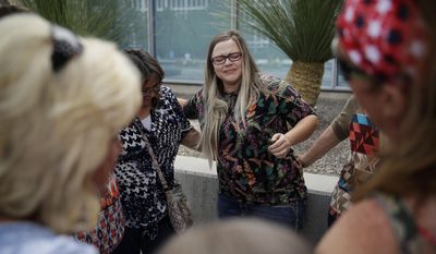 FILE - In this April 24, 2017, file photo, Bailey Logue, center, daughter of Cliven Bundy, embraces others after a partial verdict outside of the federal courthouse in Las Vegas. Federal prosecutors will try again to convince a jury that four men conspired with Nevada rancher Cliven Bundy and his family when they took up arms during a 2014 standoff that stopped federal agents from confiscating cows belonging to the states&#39; rights advocate. (AP Photo/John Locher, File)