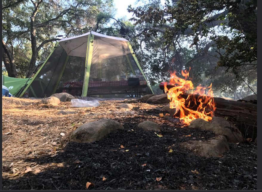 This Saturday, July 8, 2017, photo released by the Santa Barbara County Fire Department shows abandoned campsites at Cachuma Lake where visitors were forced to flee advancing flames of the Whittier fire east of Cachuma Lake in Santa Barbara County, Calif. Wildfires barreled across the baking landscape of the western U.S. and Canada, destroying a smattering of homes, forcing thousands to flee and temporarily trapping children and counselors at a California campground. Southern California crews hope slightly cooler temperatures and diminishing winds will help in the battle Sunday. (Mike Eliason/Santa Barbara County Fire Department via AP)