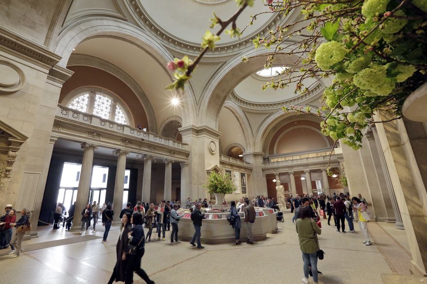 Visitors traverse the Great Hall as they enter the Metropolitan Museum of Art, in New York, Wednesday, May 10, 2017. (AP Photo/Richard Drew)