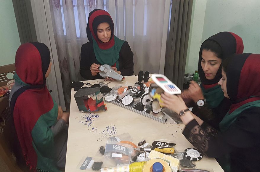 In this Thursday, July 6, 2017 photo, teenagers from the Afghanistan Robotic House, a private training institute, practice at the Better Idea Organization center, in Herat, Afghanistan. Six female students from war-torn Afghanistan who had hoped to participate in an international robotics competition July 16-18 in Washington D.C will have to watch via video link after the U.S. denied them visas -- not once, but twice. Of 162 teams participating, the Afghan girls are the only nation’s team to be denied visas. (AP Photos/Ahmad Seir)