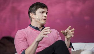 FILE - In this Nov. 19, 2016, file photo, Ashton Kutcher speaks at a panel during the Airbnb Open Spotlight at The Orpheum Theatre in Los Angeles. Kutcher explained tweeted a quick explanation on July 9, 2017, after a tabloid questioned why he was seen out and about with a mystery woman recently; it was his cousin. (Photo by Willy Sanjuan/Invision/AP, File)