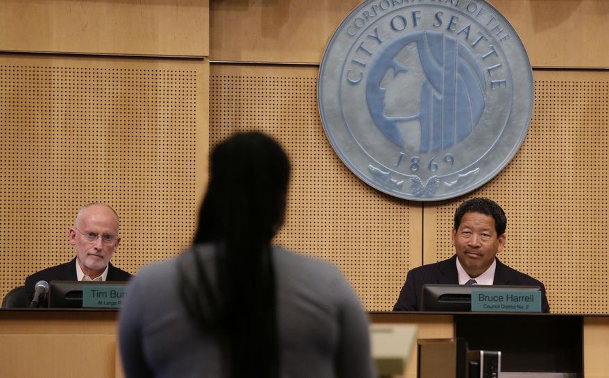 Seattle City Council members Tim Burgess, left, and president Bruce Harrell listen to Alicia Butler speak in favor of a new city income tax on the wealthy being considered, Monday, July 10, 2017, in Seattle. Seattle&#39;s highest earners would become the only Washington state residents to pay an income tax under the proposal that is designed to open a broader discussion about whether the wealthy pay their fair share in this booming city. (AP Photo/Elaine Thompson)