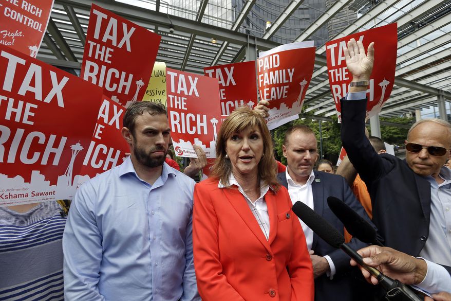 Washington State Republican Party chairman Susan Hutchison, center, speaks with media members against a new city income tax on the wealthy that was approved earlier at a Seattle City Council meeting as demonstrators holding signs in favor protest behind Monday, July 10, 2017, in Seattle. Seattle&#39;s wealthiest will become the only Washington state residents to pay an income tax under legislation unanimously approved by the City Council, a measure designed as much to raise revenue as to open a broader discussion about whether the wealthy pay their fair share. (AP Photo/Elaine Thompson)