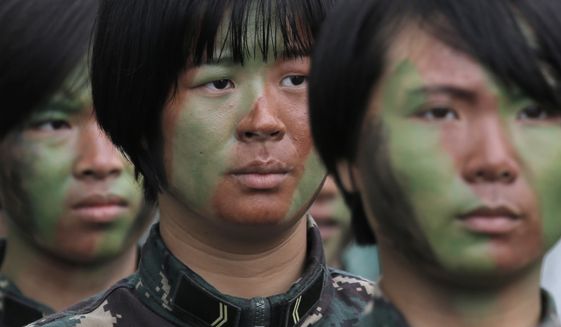 Female soldiers of Chinese People&#x27;s Liberation Army (PLA) line up before demonstrating skills during an open day of Stonecutter Island naval base in Hong Kong, Saturday, July 8, 2017, to mark the 20th anniversary of Hong Kong handover to China. China&#x27;s sole operating aircraft carrier arrived on its first port call to Hong Kong on Friday as part of efforts to stir patriotism amid commemorations of the city&#x27;s handover from British to Chinese rule 20 years ago. (AP Photo/Kin Cheung)