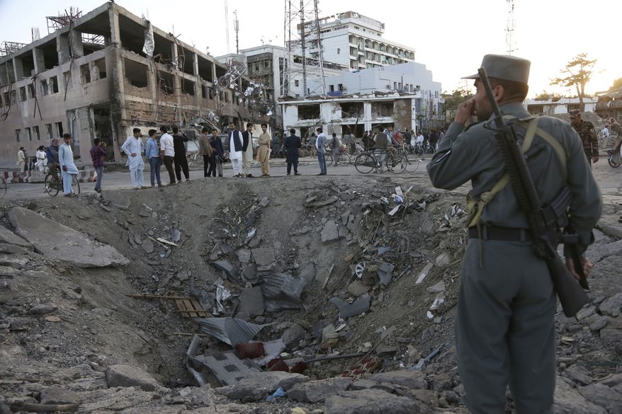 Security forces stand next to a crater created by a massive explosion that killed over 150, according to the Afghan president, in front of the German Embassy in Kabul, Afghanistan, on May 31, 2017. (Associated Press) **FILE**