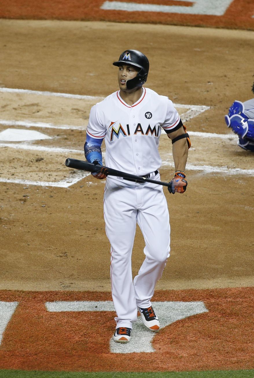 National League's Miami Marlins Giancarlo Stanton (27), walks off the field after striking out in the first inning, during the MLB baseball All-Star Game, Tuesday, July 11, 2017, in Miami. (AP Photo/Wilfredo Lee)