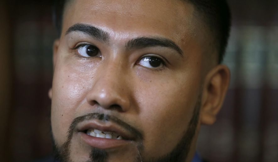 Luis Vicente Pedrote-Salinas listens to a question during a news conference Tuesday, July 11, 2017, in Chicago. Pedrote, 25, a Mexican immigrant ordered to leave the country voluntarily filed a lawsuit against Chicago police Tuesday, alleging he was wrongly listed in a gang database and that it cost him the chance to get protection through a federal program and remain in the U.S. (AP Photo/Charles Rex Arbogast)