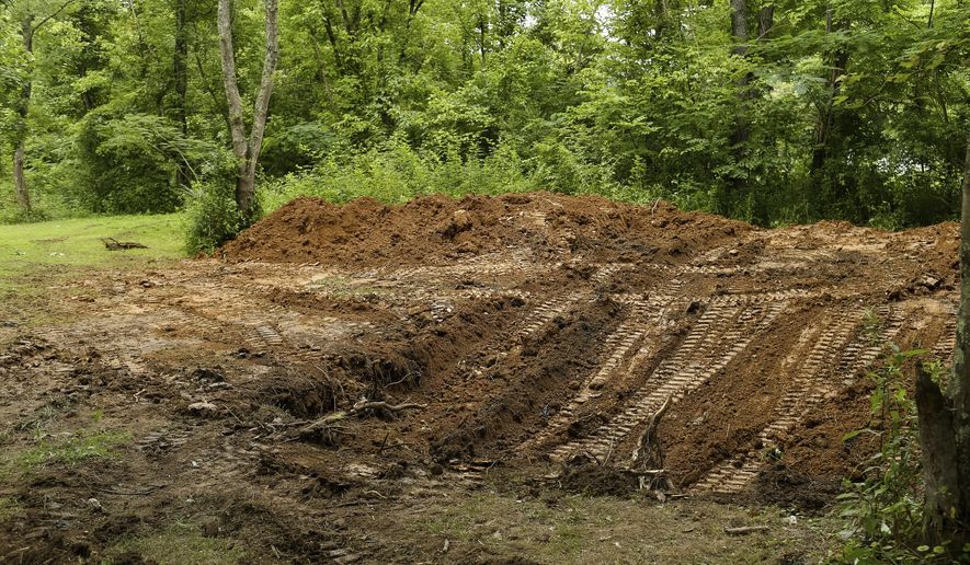 The FBI and local law enforcement searched a property located in Union Township north of Chesapeake, W.V., on Tuesday, July 11, 2017. The search began after officials responded to Facebook posts that the body of Marshall University student Samantha Burns, a 2002 murder victim whose body has never been found, was buried behind a mobile home along Township Road 1465. (Sholten Singer/The Herald-Dispatch via AP)