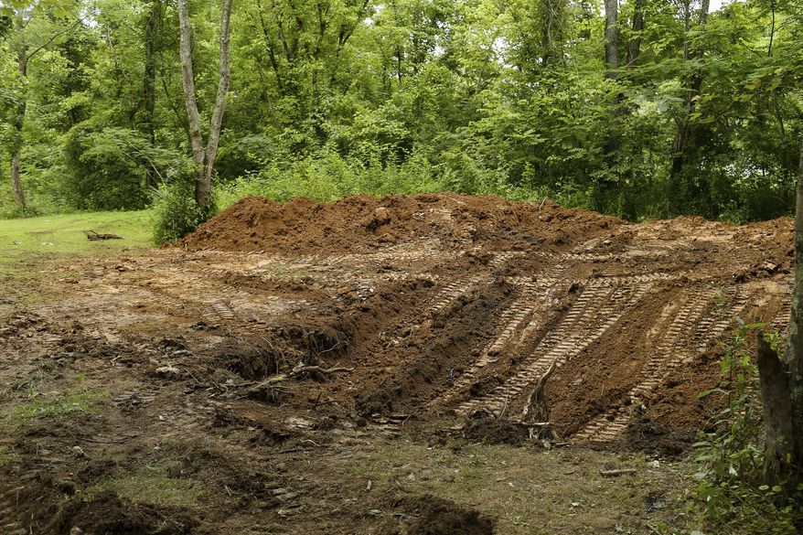 The FBI and local law enforcement searched a property located in Union Township north of Chesapeake, W.V., on Tuesday, July 11, 2017. The search began after officials responded to Facebook posts that the body of Marshall University student Samantha Burns, a 2002 murder victim whose body has never been found, was buried behind a mobile home along Township Road 1465. (Sholten Singer/The Herald-Dispatch via AP)