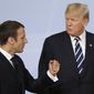 In this July 7, 2017, file photo, France&#x27;s President Emmanuel Macron talks with U.S. President Donald Trump after the family photo on the first day of the G-20 summit in Hamburg, Germany. (AP Photo/Michael Sohn, File)