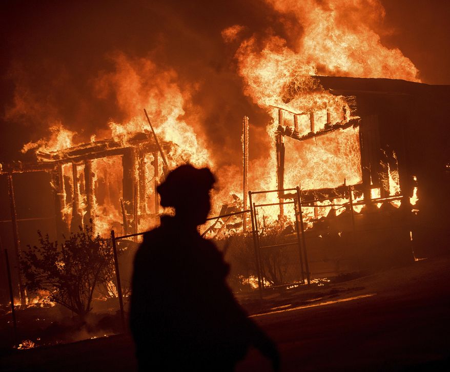 Flames from a wildfire consume a residence near Oroville, Calif., on Sunday, July 9, 2017. Evening winds drove the fire through several neighborhoods leveling homes in its path. (AP Photo/Noah Berger)