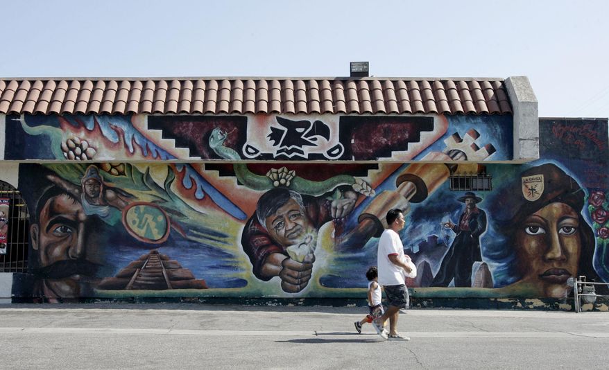 FILE - In this July 19, 2008 file photo a mural named Raza Adelante, including the image of Cesar Chavez, center, is seen on Cesar Chavez Avenue in unincorporated East Los Angeles. The term la raza has deep roots in Mexico after that country’s revolution and in the U.S. Chicano Movement of the 1970s which helped elect some of the nation's first Latinos to public office. The National Council of La Raza announced that it was changing its name to drop the term "la raza," which menas the people. At political rallies in Texas and during California marches in support for Cesar Chavez’s United Farm Workers, young Latino activists yelled, “Viva La Raza!” (AP Photo/Reed Saxon, File)