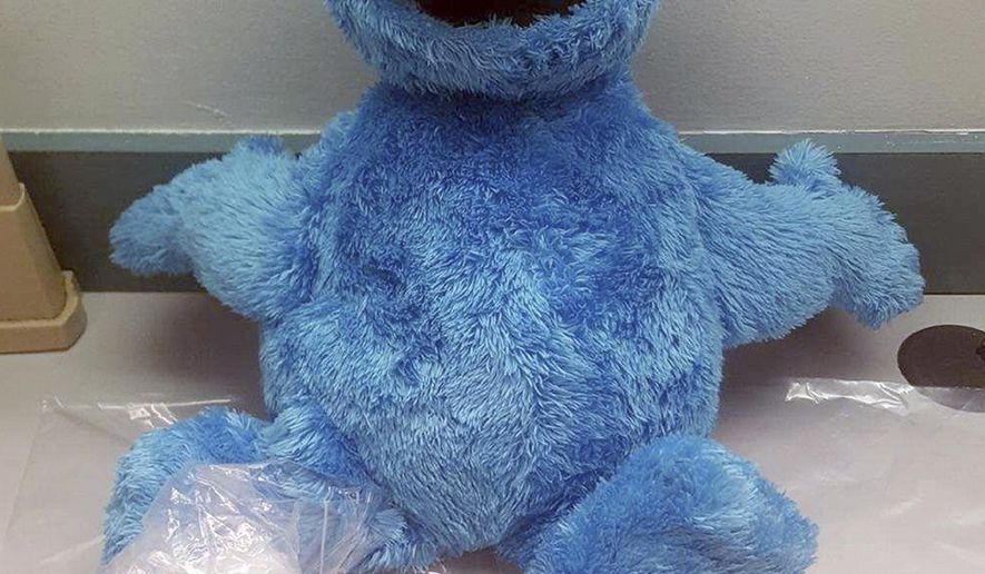 This undated photo provided by the Monroe County Sheriff's Office, shows the Cookie Monster doll discovered by a deputy with two packages of cocaine hidden inside. The Monroe County Sheriff's Office said in a news release Wednesday, July 12, 2017, that 39-year-old Camus McNair was arrested after a Florida Keys traffic stop involving a car with heavily tinted windows and an obscured license plate. (Deputy Matthew Cory/Monroe County Sheriff's Office via AP)