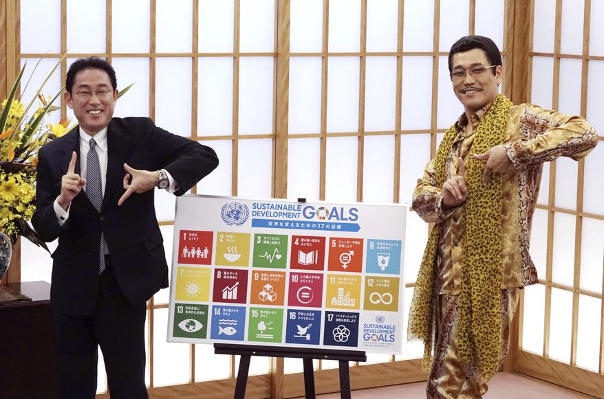 Japanese comedian Pikotaro, right, and Japan&#x27;s Foreign Minister Fumio Kishida pose to raise awareness about the United Nation&#x27;s 17 Sustainable Development Goals (SDGs) at the ministry in Tokyo, Wednesday, July 12, 2017. Pikotaro, who has gained global fame with his &amp;quot;pen-pineapple-apple-pen&amp;quot; song, will debut at the United Nations with a new version of PPAP to promote sustainable development.(AP Photo/Eugene Hoshiko)