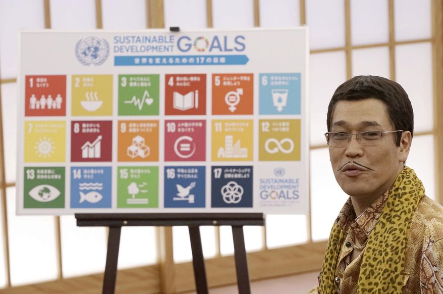 Japanese comedian Pikotaro talks with Japanese Foreign Minister Fumio Kishida during a meeting at the ministry in Tokyo, Wednesday, July 12, 2017. Pikotaro, who has gained global fame with his “pineapple-pen-apple-pen” song, will debut at the United Nations with a new version of PPAP to promote sustainable development. Pikotaro, appointed by the Foreign Ministry to promote U.N. sustainable development goals, recently created a SDGs version of the PPAP song. (AP Photo/Eugene Hoshiko)