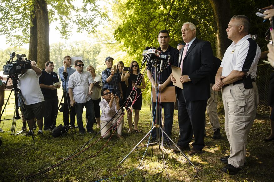 Matthew Weintraub, District Attorney for Bucks County, Pa., second right, speaks with members of the media, Wednesday, July 12, 2017, in Solebury, Pa., as the search continues for four missing young Pennsylvania men feared to be the victims of foul play. (AP Photo/Matt Rourke)