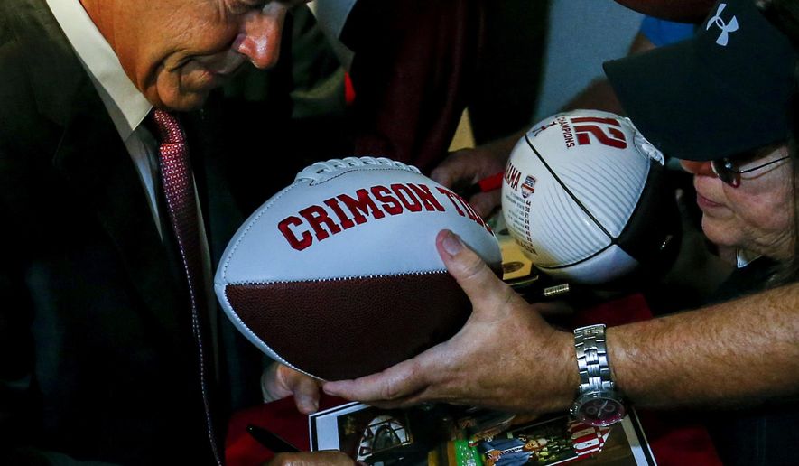 Alabama NCAA college football coach Nick Saban signs an autograph for fans during the Southeastern Conference's annual media gathering, Wednesday, July 12, 2017, in Hoover, Ala. (AP Photo/Butch Dill)