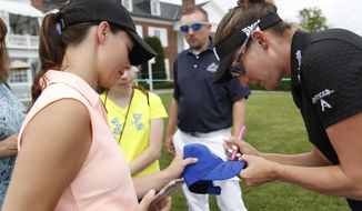 Brittany Lang signs a hat for a fan during a practice round for the U.S. Women&#39;s Open Golf Championship at Trump National Golf Club in Bedminster, N.J., Wednesday, July 12, 2017. (AP Photo/Seth Wenig)