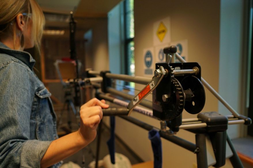 Michelle Bebber, a PhD archaeology student at Kent State University, loads a bow with a recreated ancient arrow in Kent, Ohio. Bebber conducts research at a newly-opened laboratory which makes replicas of ancient arrows, knives, and pottery to be shot, crushed, and smashed. It's allowing researchers to learn about engineering techniques of the first native Americans without destroying priceless genuine relics in the process. (AP Photo/Dake Kang)