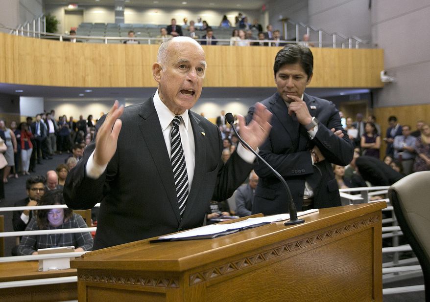 California Gov. Jerry Brown, left, flanked by Senate President Pro Tem Kevin de Leon, D-Los Angeles, urges members of the Senate Environmental Quality Committee to approve a pair of bills to extend state&#x27;s cap and trade program, Thursday, July 13, 2017, in Sacramento, Calif. (AP Photo/Rich Pedroncelli)