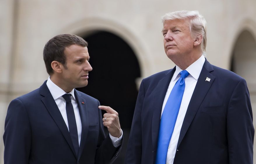 French President Emmanuel Macron, left, talks to U.S President Donald Trump while leaving Les Invalides museum in Paris, Thursday, July 13 2017 as part of Trump's visit to France for Bastille Day celebrations in Paris. (Ian Langsdon, Pool via AP)