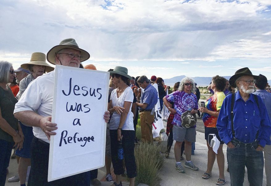 Demonstrators rally in support of Iraqi refugee Kadhim Al-bumohammed outside of Immigration and Customs Enforcement offices in Albuquerque on Thursday, July 13, 2017. Al-bumohammed opted to skip his scheduled federal immigration hearing Thursday where he was expected to be detained, and instead said he is seeking sanctuary at an Albuquerque church. (AP Photo/Russell Contreras)