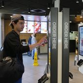 In this Thursday, June 1, 2017, photo, Brandon Alba from Milwaukee, orders food at a self-service kiosk at a McDonald&#x27;s restaurant in Chicago. The company that helped define fast food is making supersized efforts to reverse its fading popularity and catch up to a landscape that has evolved around it. That includes expanding delivery, digital ordering kiosks in restaurants, and rolling out an app that saves precious seconds. (AP Photo/Charles Rex Arbogast) **FILE**
