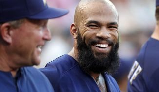FILE - In this June 14, 2017, file photo, Milwaukee Brewers&#39; Eric Thames smiles in the dugout after hitting a two-run home run against the St. Louis Cardinals during a baseball game in St. Louis. “It’s good to see on TV, the press, everyone starting to realize that the team’s a force to be reckoned with,” Thames said with a smile on Thursday, July 13, before an early-evening team workout at Miller Park “I’m digging it. I’m ready to start the second half.” It has been quite a season so far for a club that was supposed to be in the second full year of a rebuilding project. At 50-41, Milwaukee is in first place at the break for the fifth time in franchise history, and the first time since 2014. (AP Photo/Jeff Roberson, File)