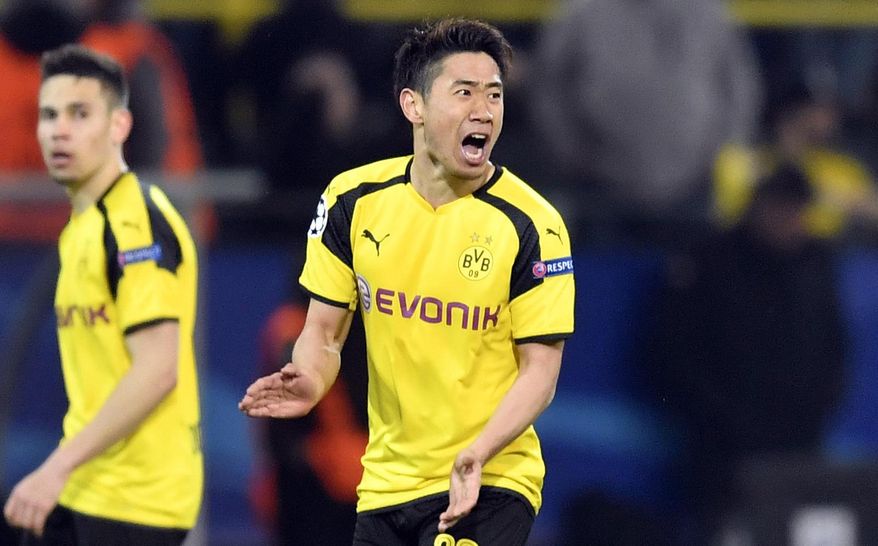 FILE - In this Wednesday, April 12, 2017 file photo, Dortmund's Shinji Kagawa celebrates after scoring his side's second goal during the Champions League quarterfinal first leg soccer match between Borussia Dortmund and AS Monaco in Dortmund, Germany. Japan star Shinji Kagawa has extended his contract with Borussia Dortmund contract by two years until June 2020. (AP Photo/Martin Meissner, File)