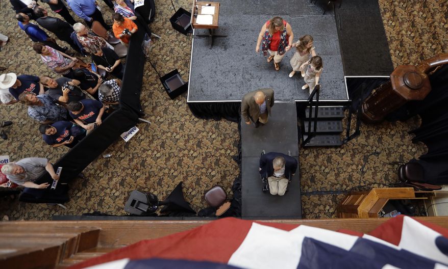 Texas Gov. Greg Abbott, bottom center right, leaves the stage after he announced his bid for re-election, Friday, July 14, 2017, in San Antonio. (AP Photo/Eric Gay)