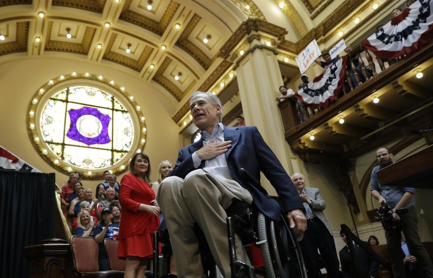 Texas Gov. Greg Abbott gestures to supporters as he and his wife, Cecilia, arrive for an event where he announced his bid for re-election, Friday, July 14, 2017, in San Antonio. (AP Photo/Eric Gay)