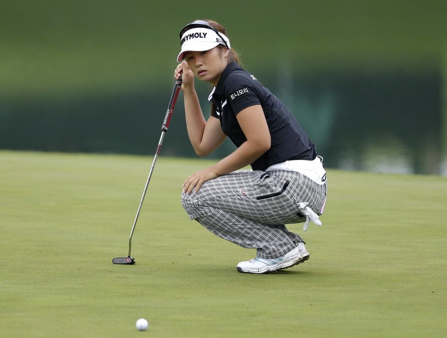 Jeongeun6 Lee, of South Korea, lines up a putt on the 16th green during the second round of U.S. Women's Open Golf Championship at Trump National Golf Club in Bedminster, N.J., Friday, July 14, 2017. She uses the number 6 because there are six Korean golfers with similar names and she wants her fans to know which one she is when mentioned. (AP Photo/Seth Wenig)